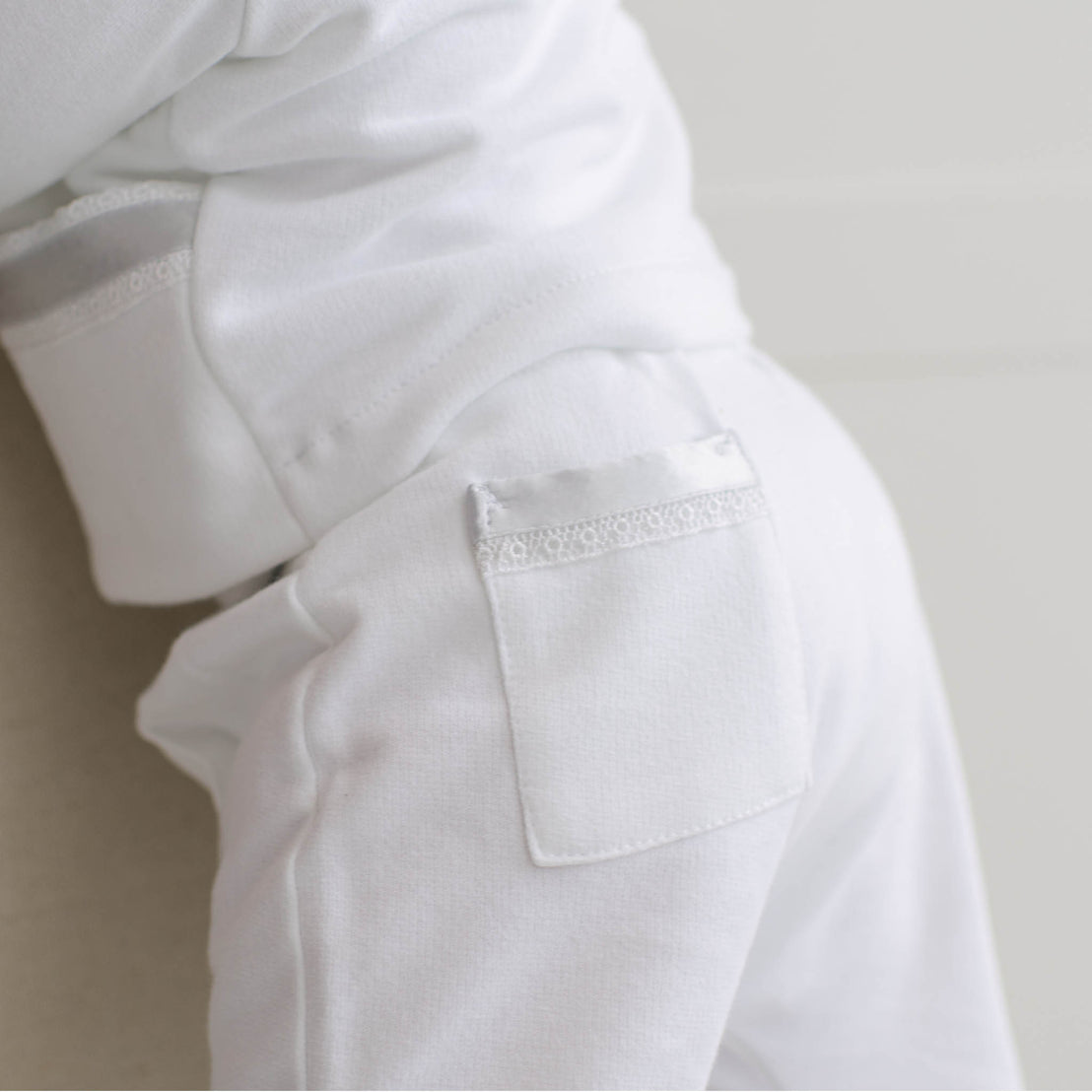 Close-up of a white shirt with a pocket on a light background