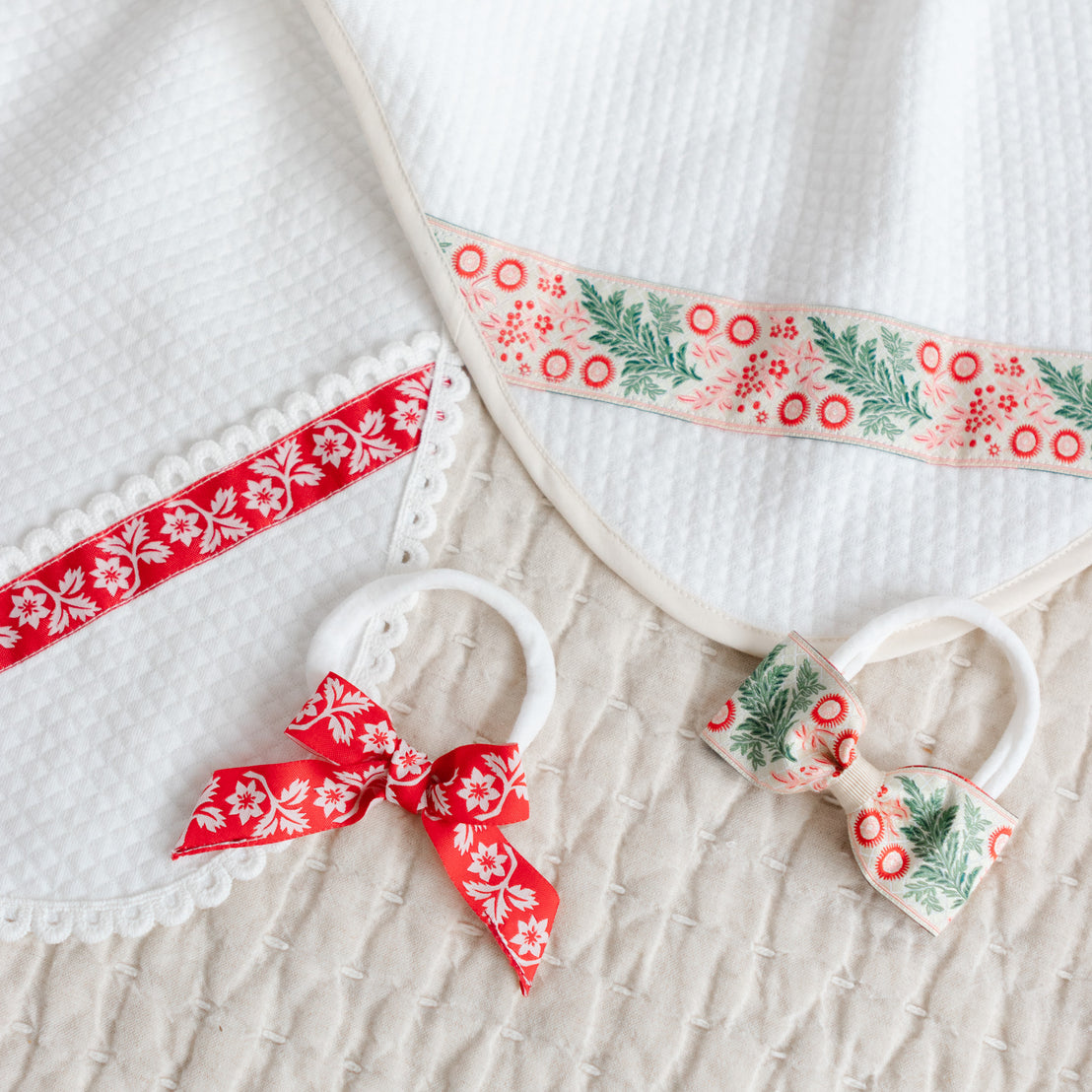 Two bow headbands and quilted blankets with matching ribbons.