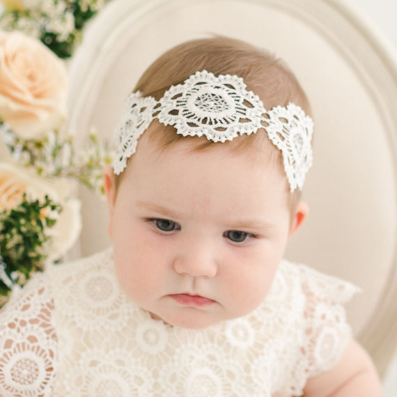 Baby girl wearing a large lace headband - part of the Baby Beau & Belle Poppy Collection.