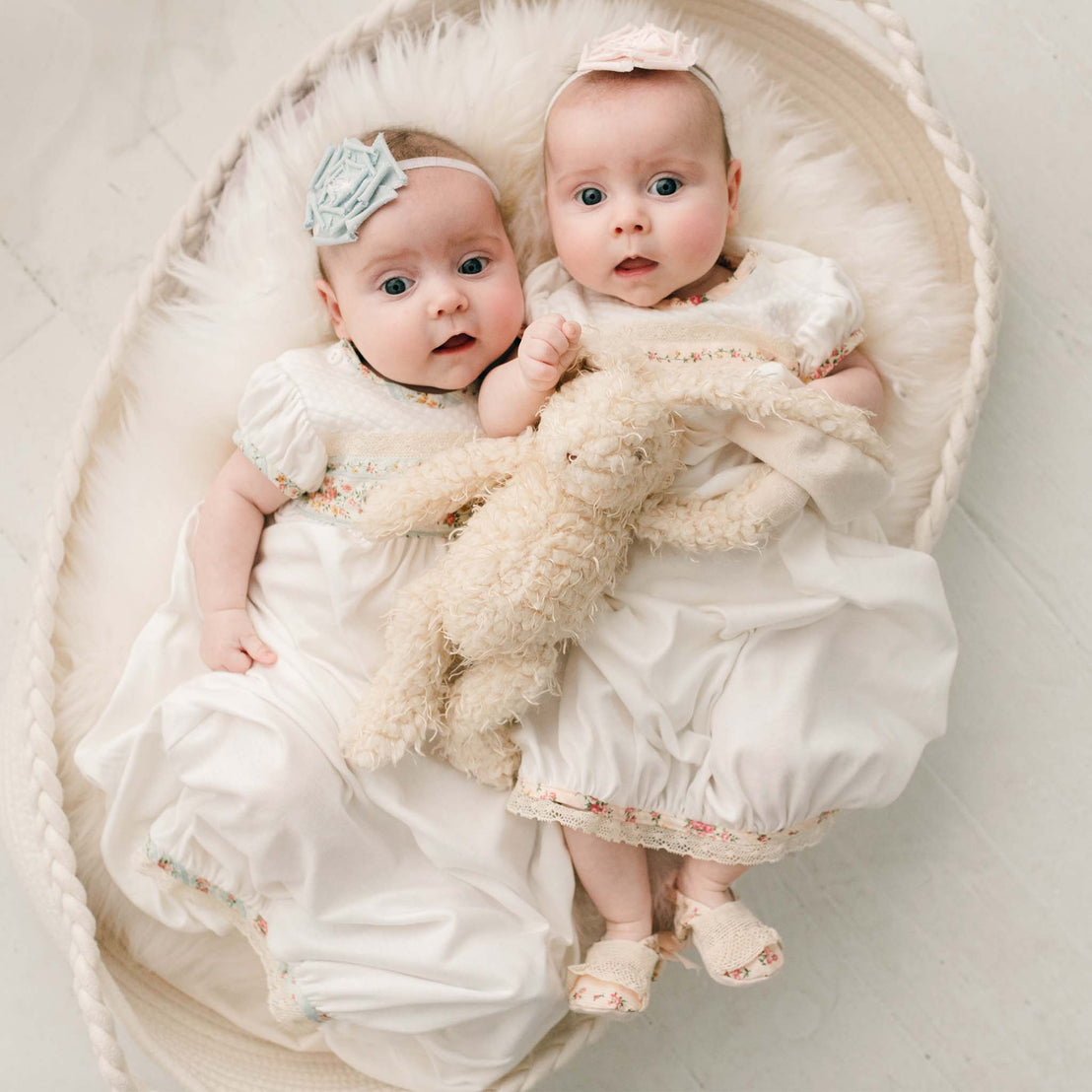 Two twin baby newborn girls with the Eloise Bunny, a super soft stuffed animal with a tan scraggly fur body.
