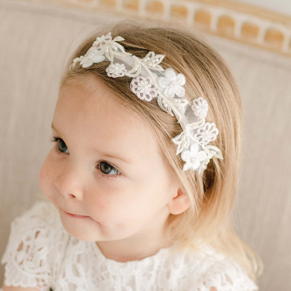 Baby girl wearing a Lola Beaded Flower Headband. Accented with beautiful Lola floral appliqué.