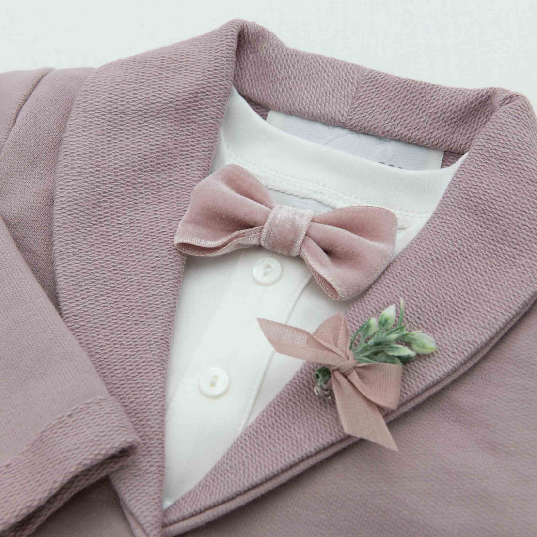 Flat lay photo of the Ezra Mauve Jacket, featuring the velvet bowtie and boutonniere 