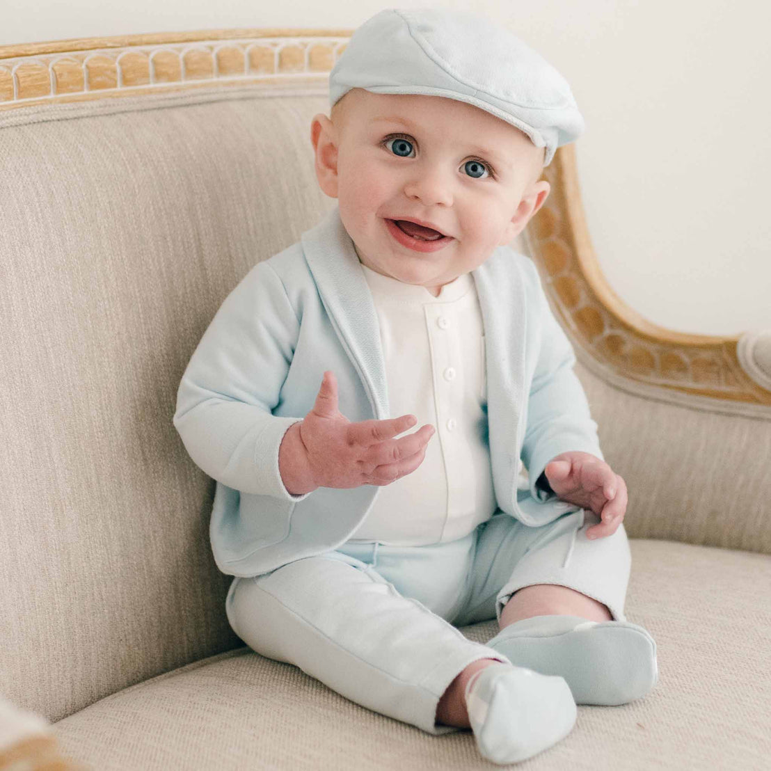 Sitting baby boy in robin's egg blue suit and newsboy cap
