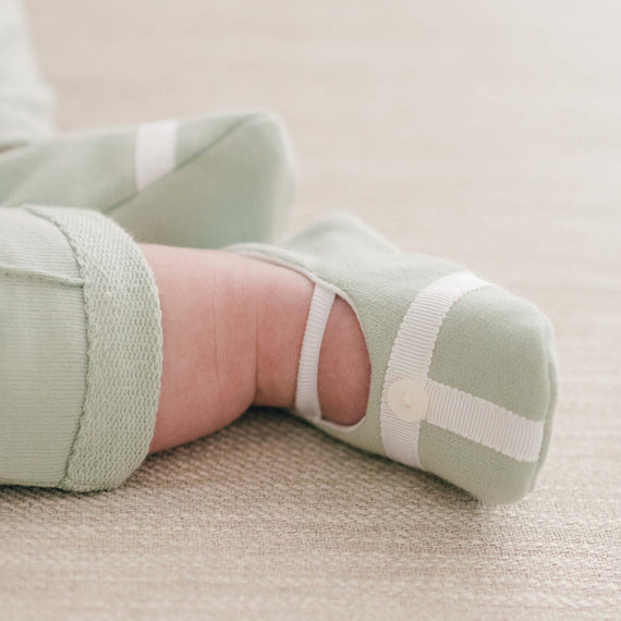 Baby boy in sage green cotton and ribbon booties