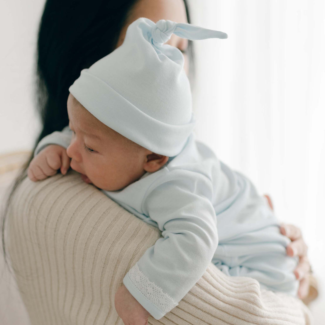 Baby boy with Mom wearing blue knot style cap\