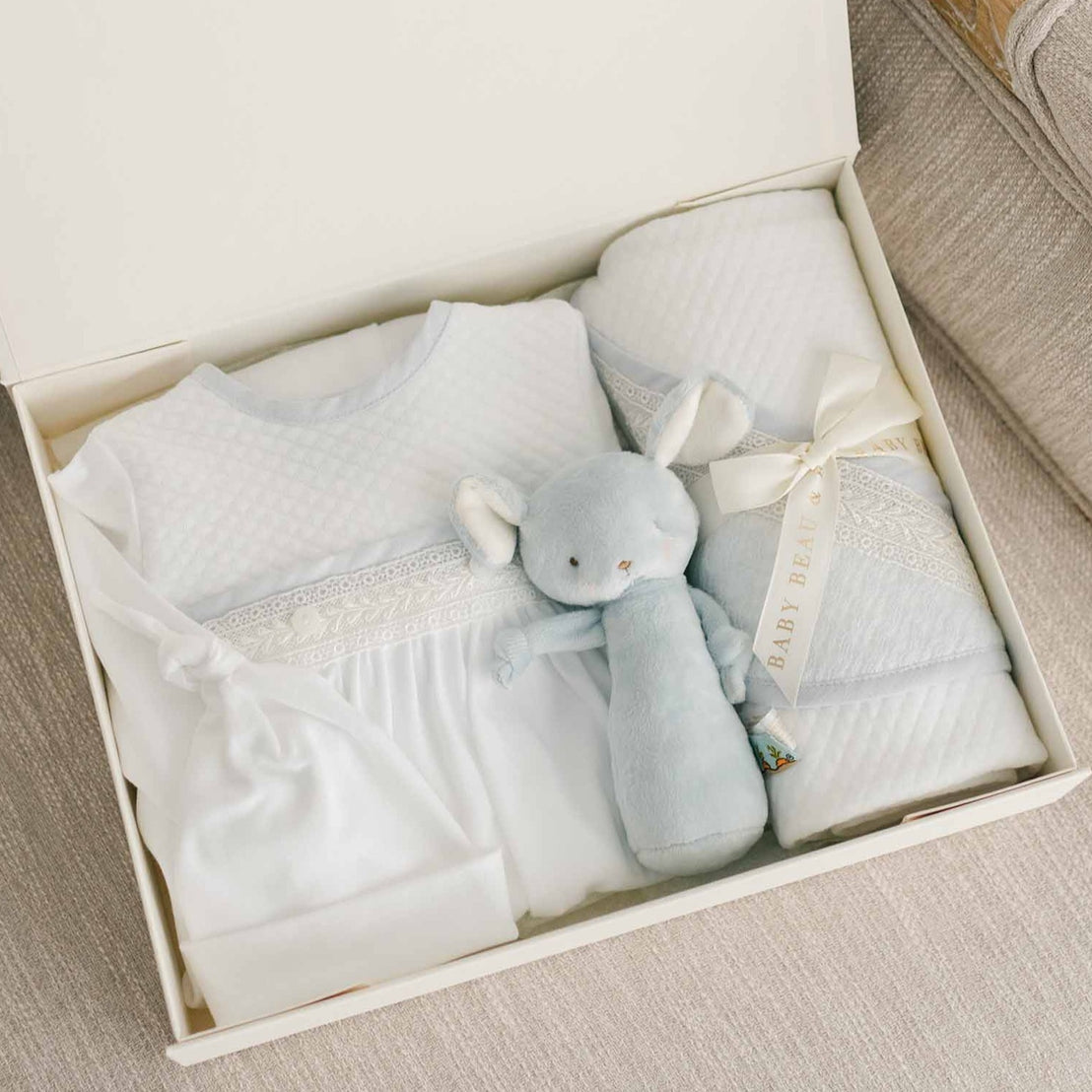 Photo of the Harrison Newborn Gift Set, which includes the Layette Gown, Bonnet (or Knot Cap), Rattle, Blanket, and Gift Box.