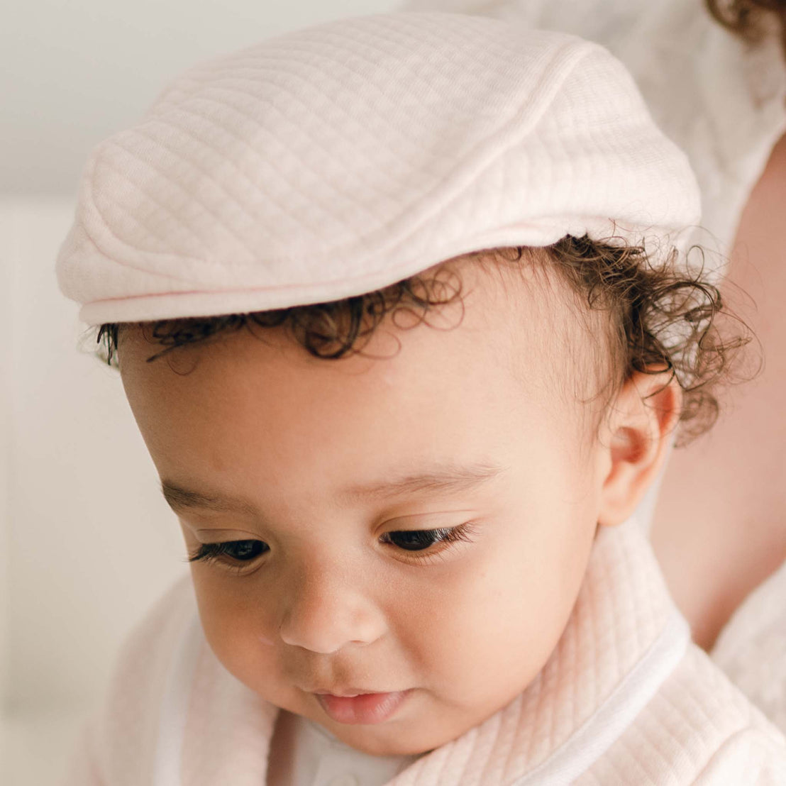 Baby boy wearing the pink Asher Quilted Newsboy Cap made from 100% Quilted Cotton with a soft elastic back.