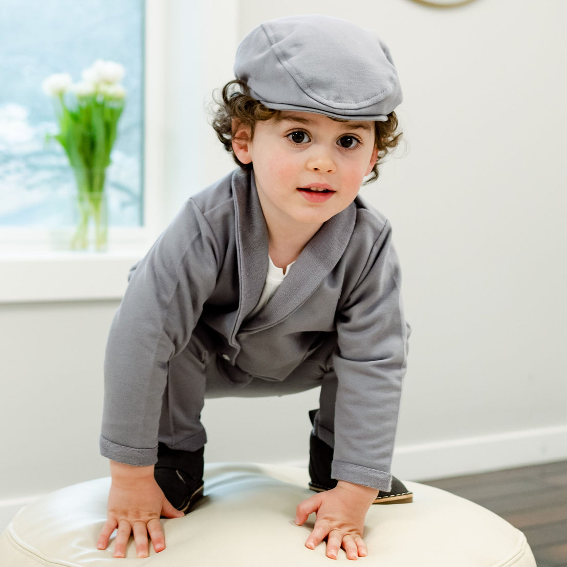 Toddler boy in grey cotton hat and suit