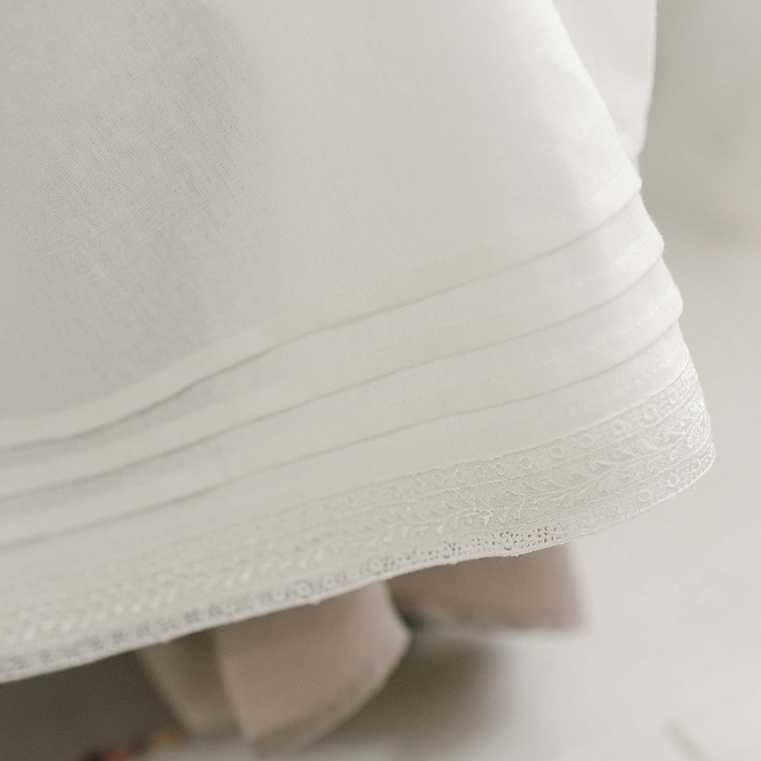 Flat lay photo of the ivory Oliver Convertible Skirt showcasing the hem detail on the ivory linen skirt.