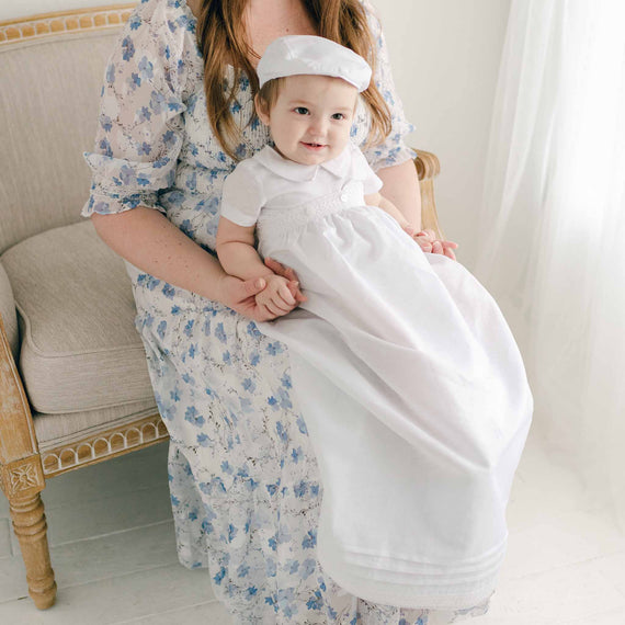 Baby boy wearing the convertible baptism gown and Romper Skirt Set. The skirt attaches to the Oliver Romper to turn the romper into a traditional christening gown.