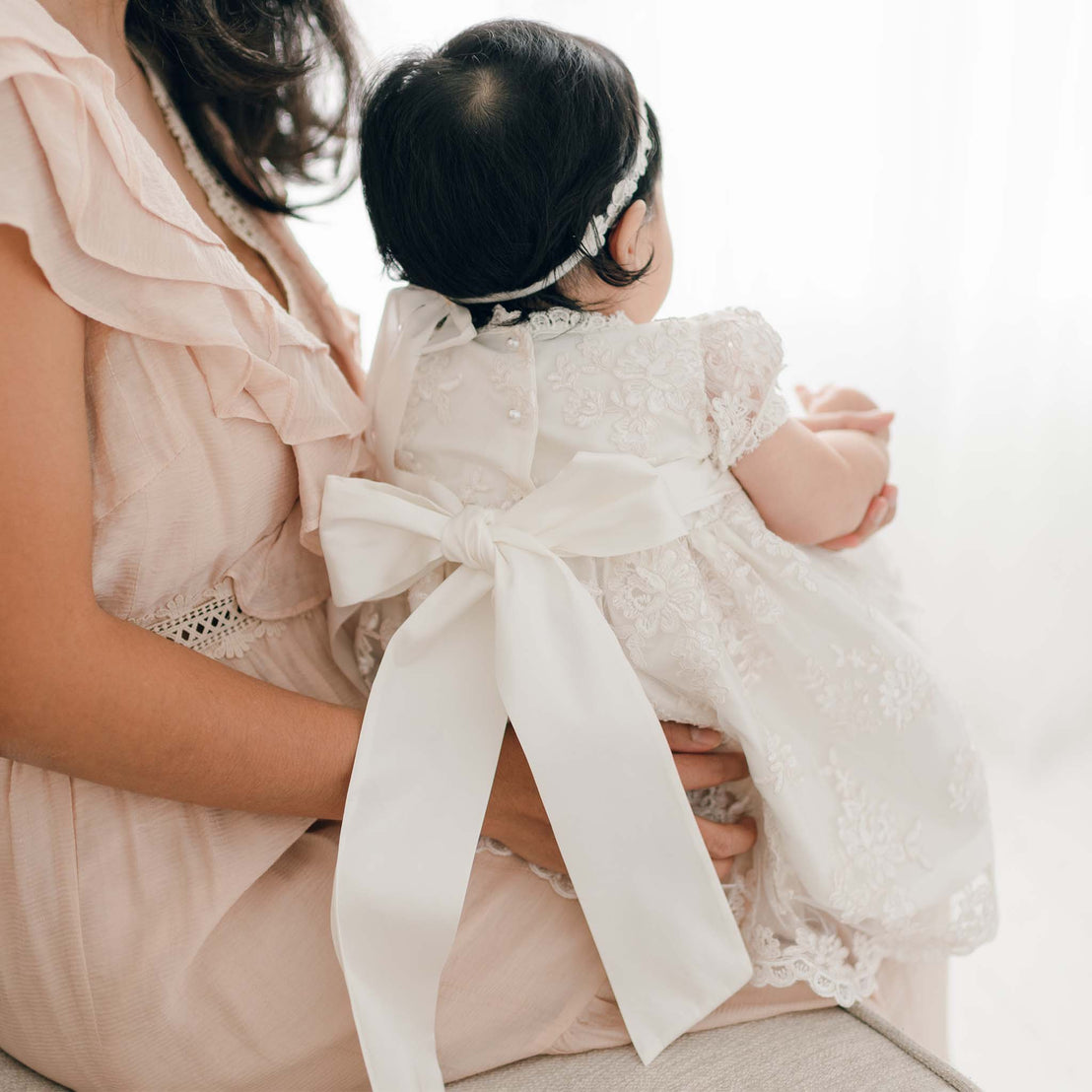 Silk sash tie on back of traditional baby girl christening dress