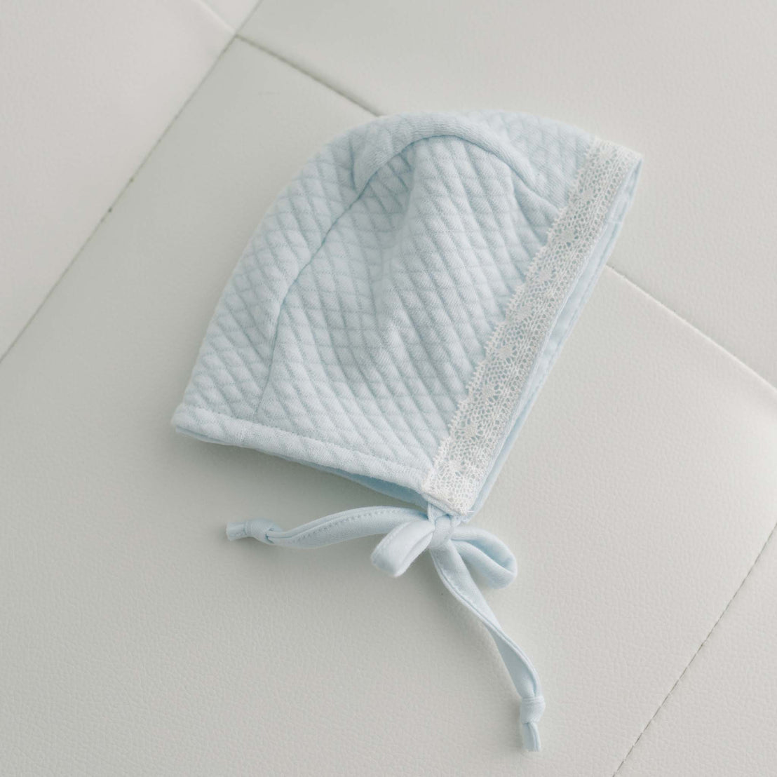 Side of blue textured cotton baby boy bonnet