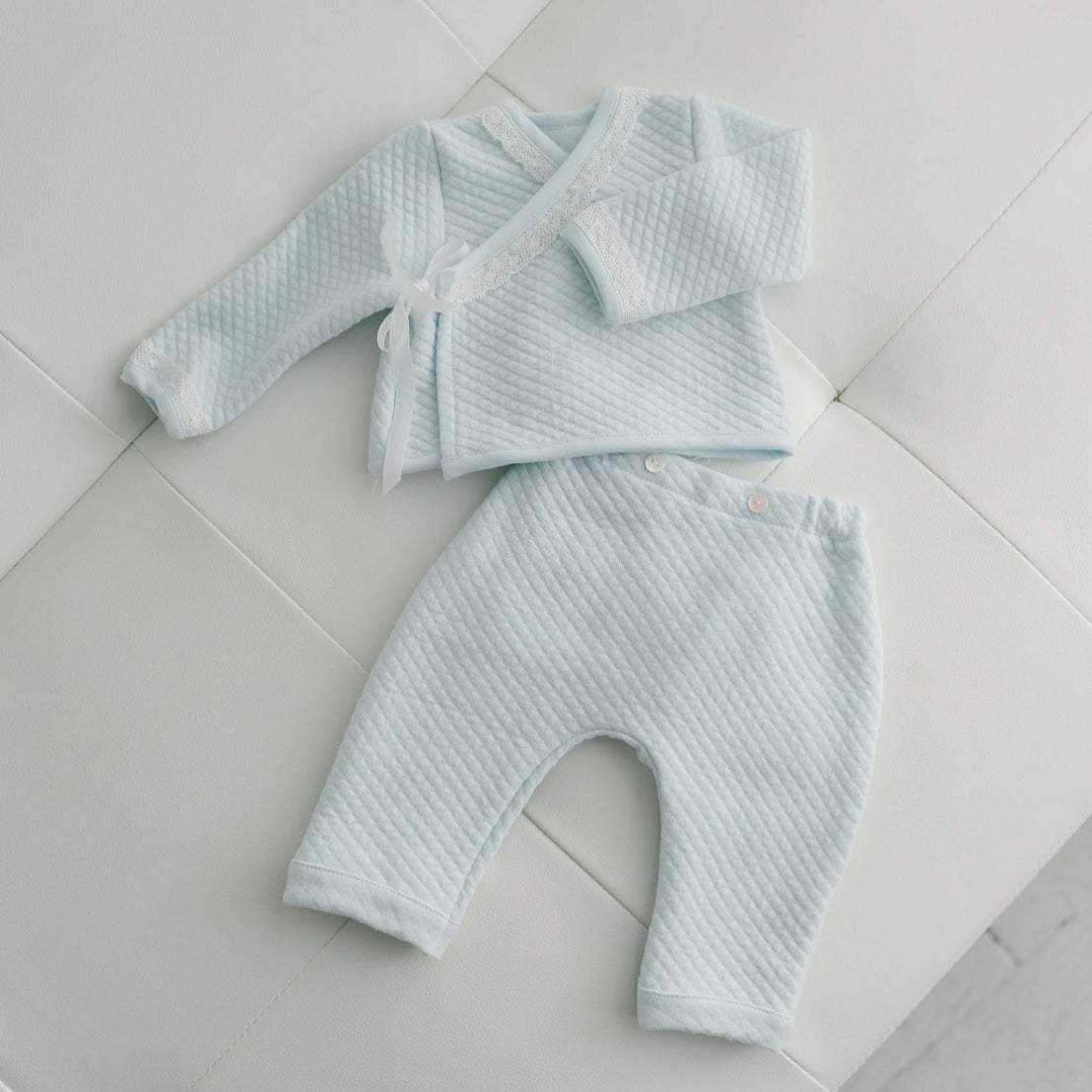 Blue quilt wrap top and pants flat lay baby take me home