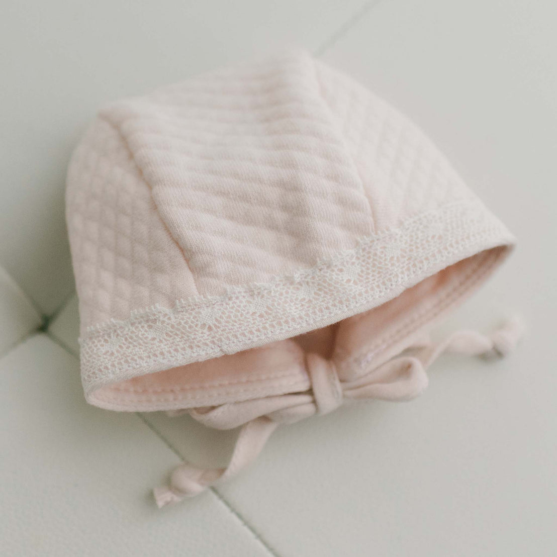 Top of pink cotton baby girl bonnet