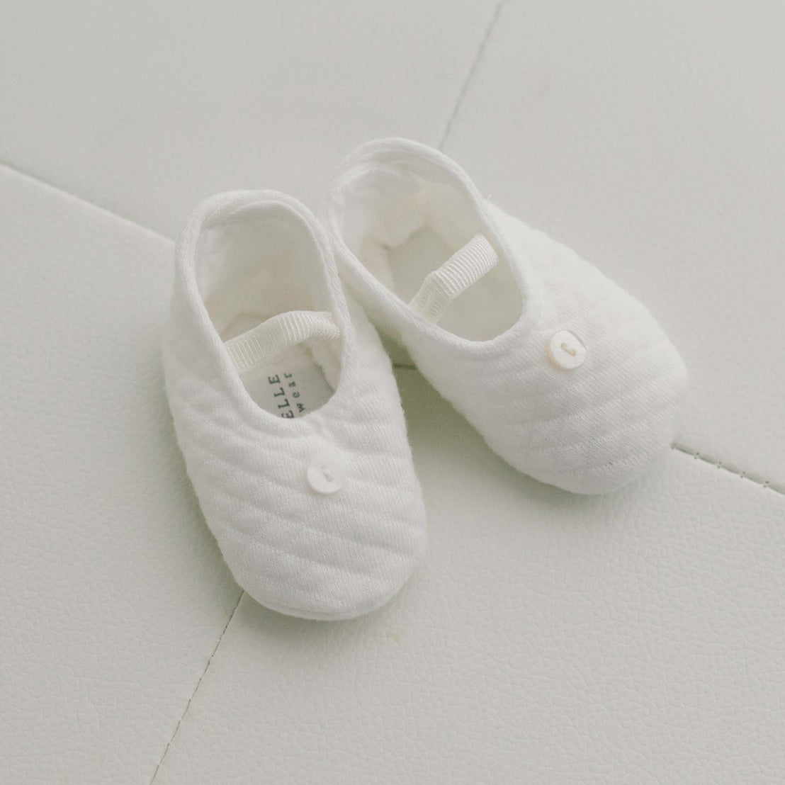Pair of ivory cotton baby booties