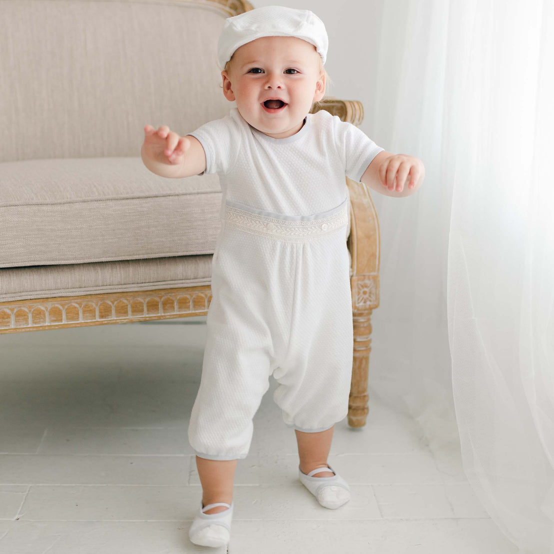 Baby boy smiles and walks as he wears the Harrison Short Sleeve Romper