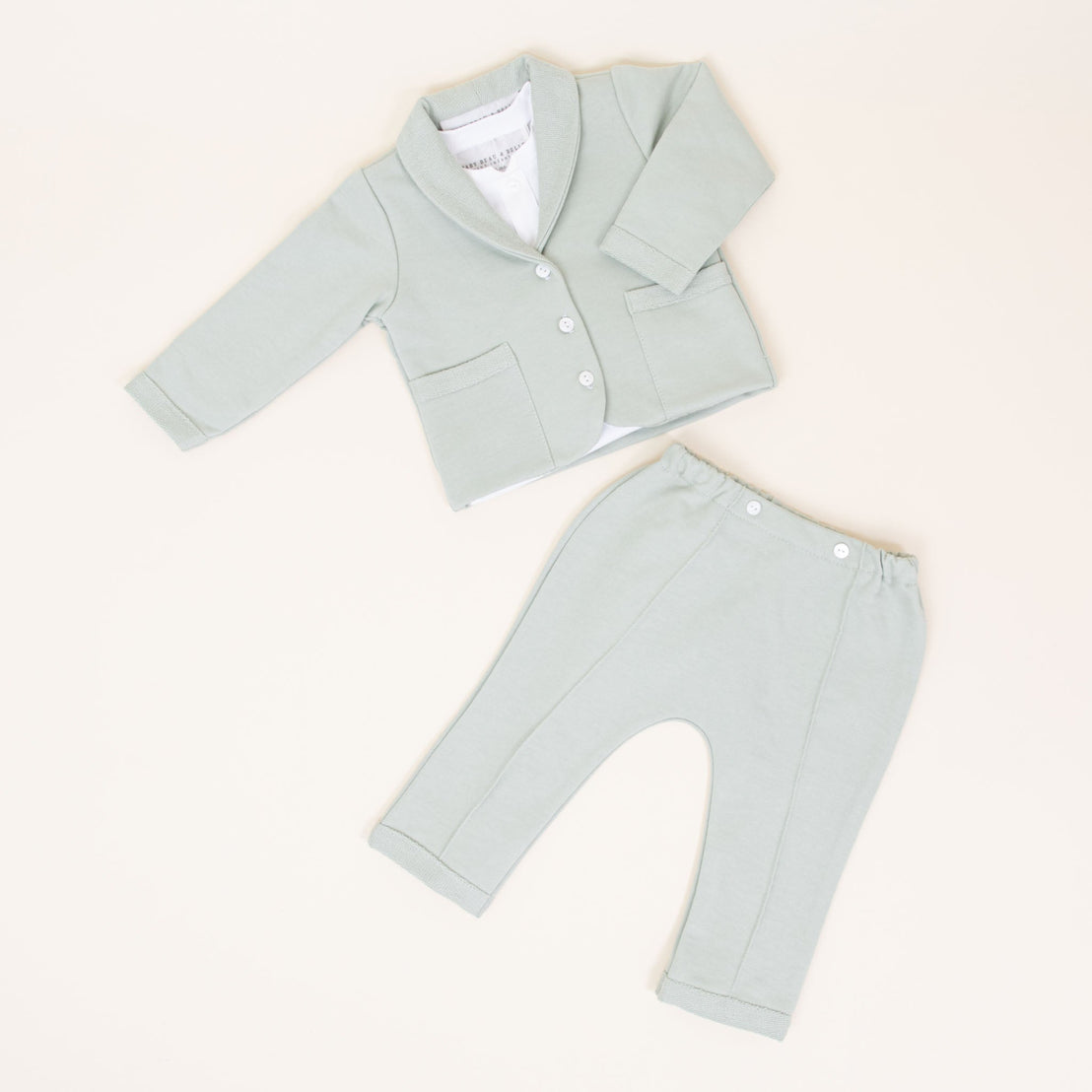 Flat lay of sage green cotton suit
