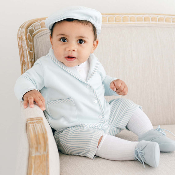 Baby boy sitting and wearing the Theodore Shorts Suit in Robin's Egg blue. The Theodore Shorts Suit includes a jacket, shorts, and onesie. 