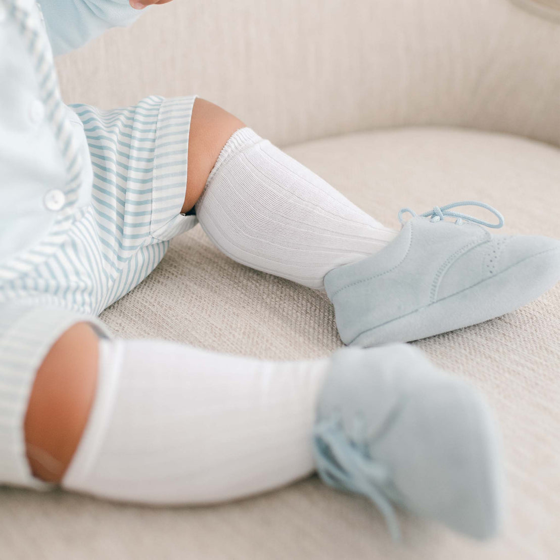 Baby boy wearing the Boys White Knee Socks made from cotton/nylon and spandex.