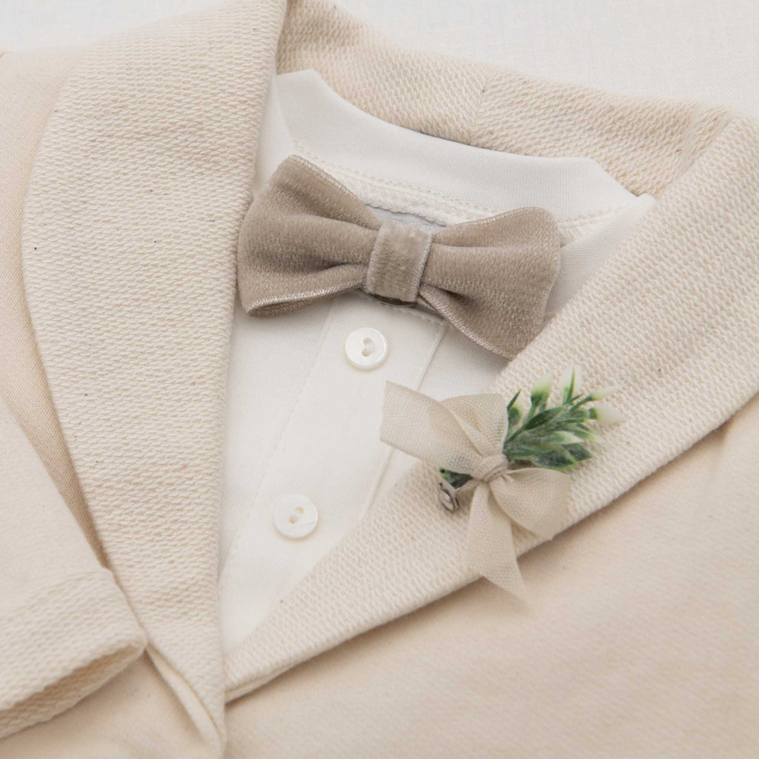 Flat lay photo of the Ezra Tan Velvet Bow Tie and Boutonniere