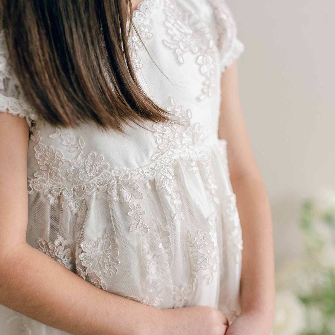 Close-up of the Penelope Lace Dress bodice, highlighting the embroidered lace detail.