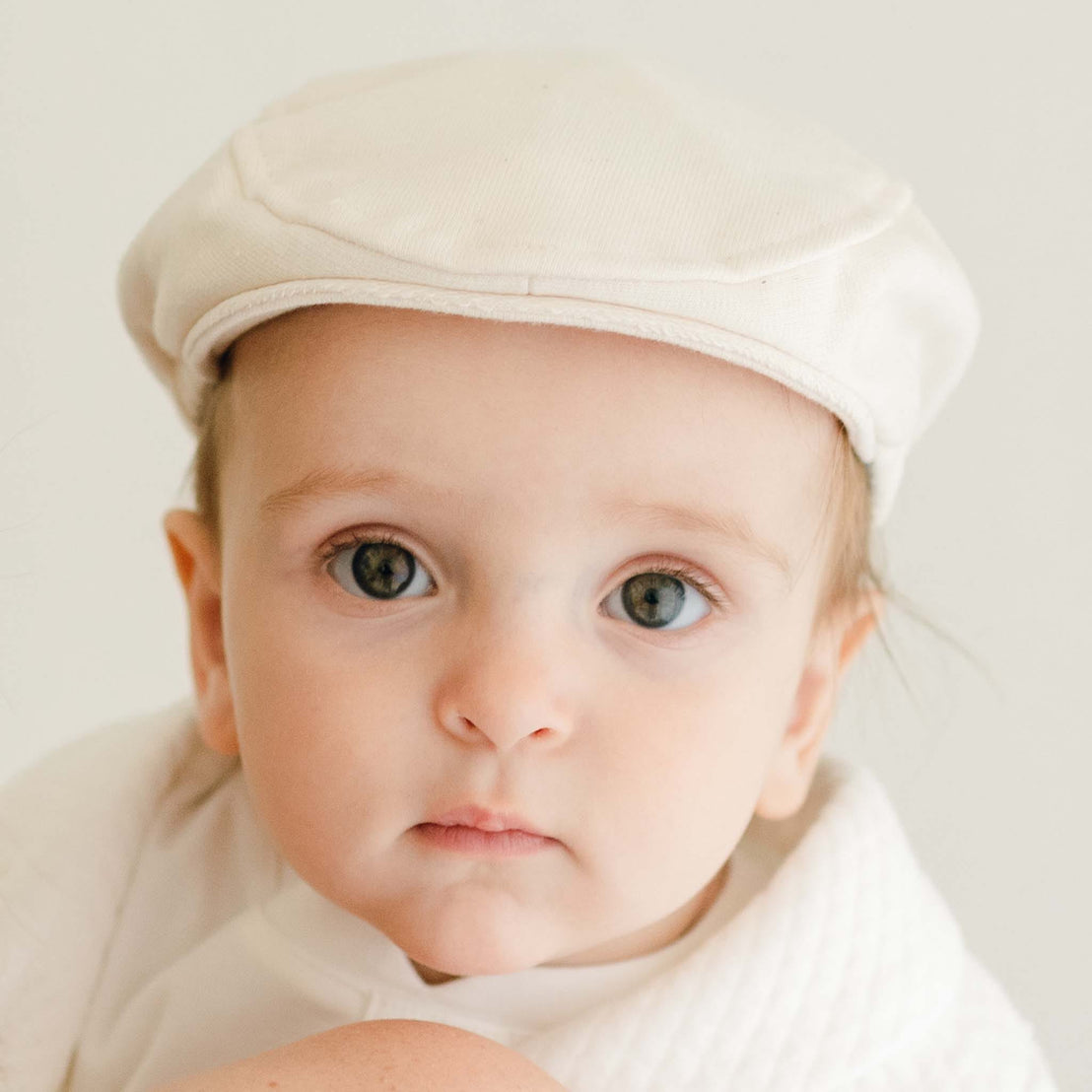 Baby boy wearing the Braden Newsboy Cap made from ivory french terry