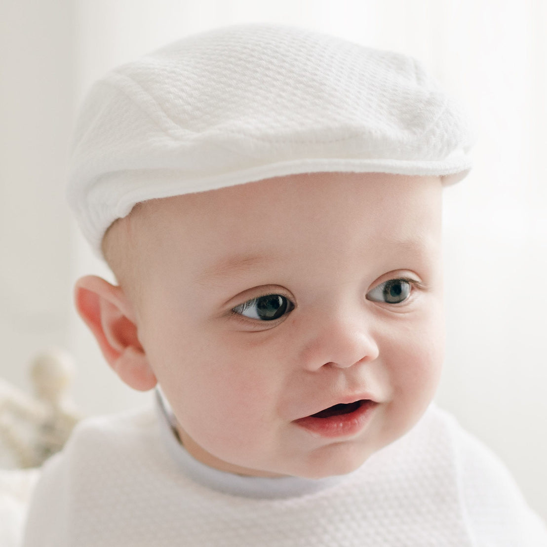A close-up of a baby in the Harrison Textured Newsboy Cap, highlighting the textured fabric and structured brim.