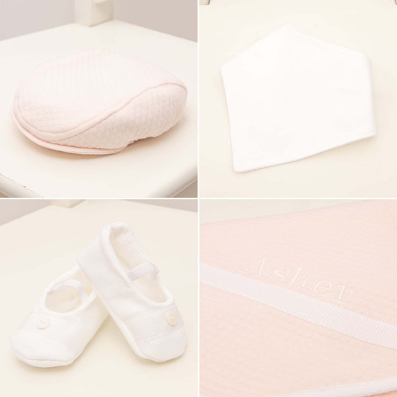 A delightful set of pastel pink and white baby essentials, featuring a quilted baby cap, soft bib, tiny booties, and the standout Asher Blush personalized quilted blanket with "Asher" beautifully embroidered on it—all artistically arranged on a pristine white background. Part of the Asher Blush Suit Accessory Bundle that offers a 15% savings.