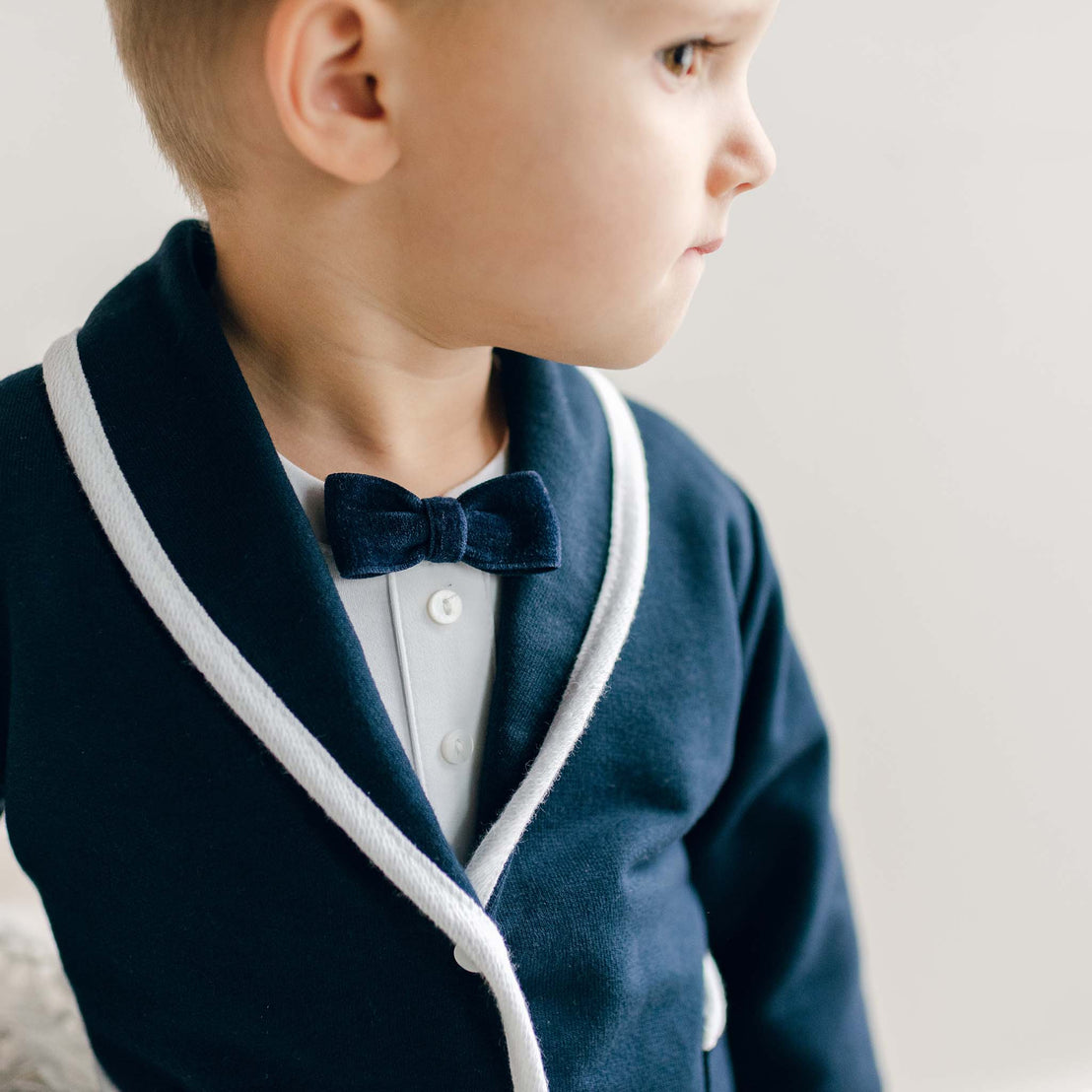 Close-up of the Elliott 3-Piece Suit showing the navy jacket with white trim and matching bow tie.