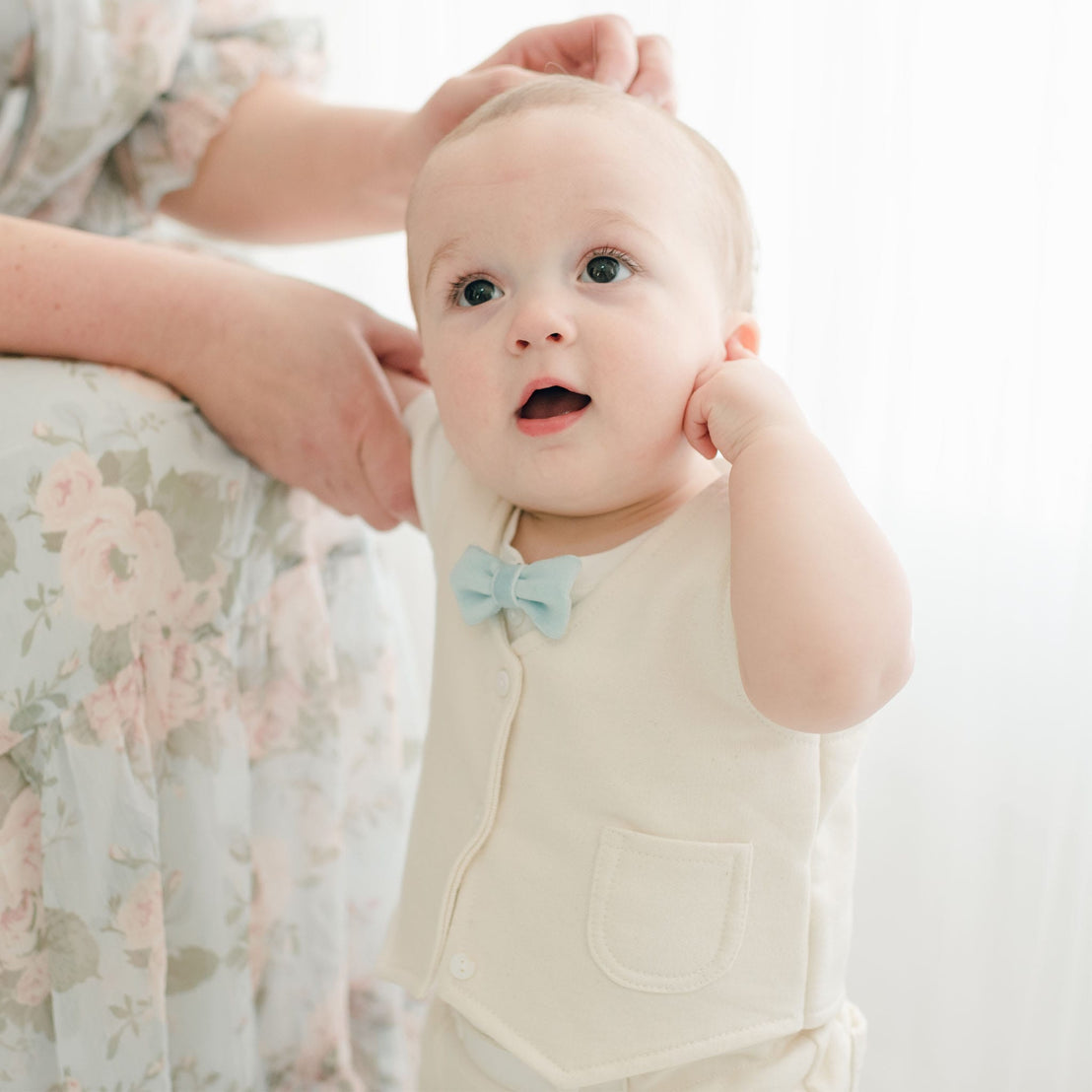 A baby wearing the Ezra Powder Blue 4-Piece Suit without the jacket, showing the ivory vest and blue velvet bow tie.
