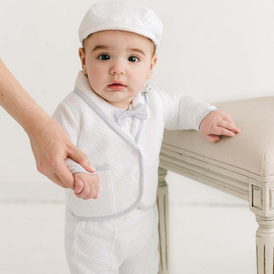 Toddler holding a parent's hand while standing in the Harrison 3-Piece Pants Suit, showcasing the tailored jacket and fitted pants.