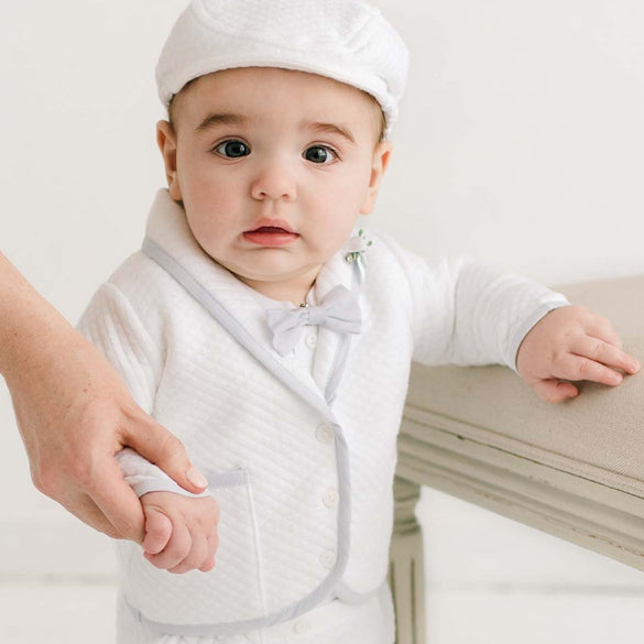 Toddler holding a parent's hand while standing in the Harrison 3-Piece Pants Suit, showcasing the tailored jacket and fitted pants perfect for boys christening outfit