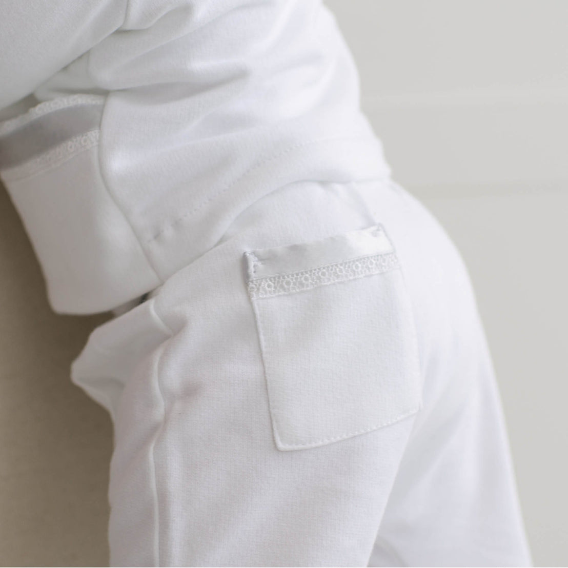 Close-up of the back of the Henry 3-Piece Suit Pant. The back pocket features Venice lace and blue silk ribbon detailing.