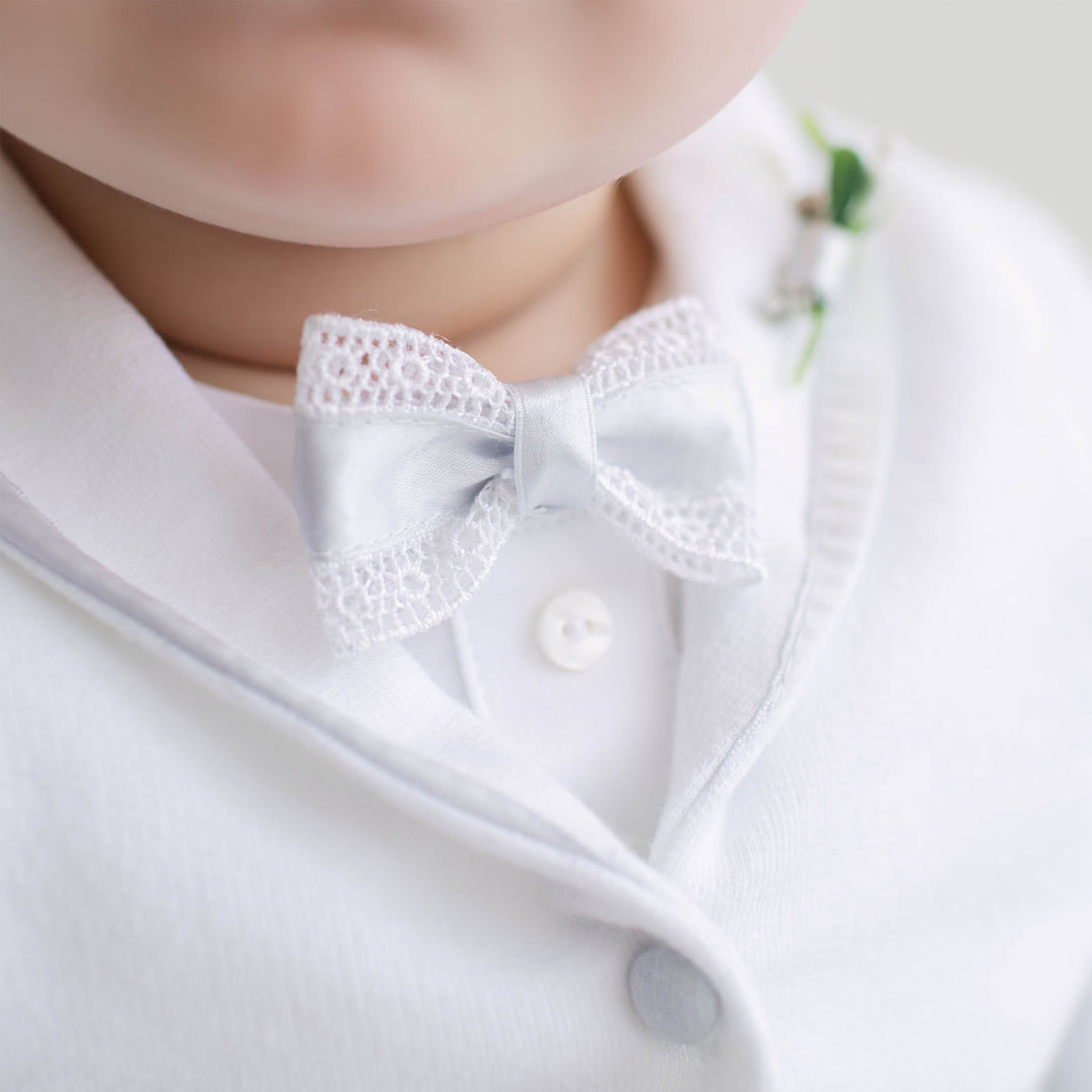 Close-up of a lace bowtie with blue silk detail