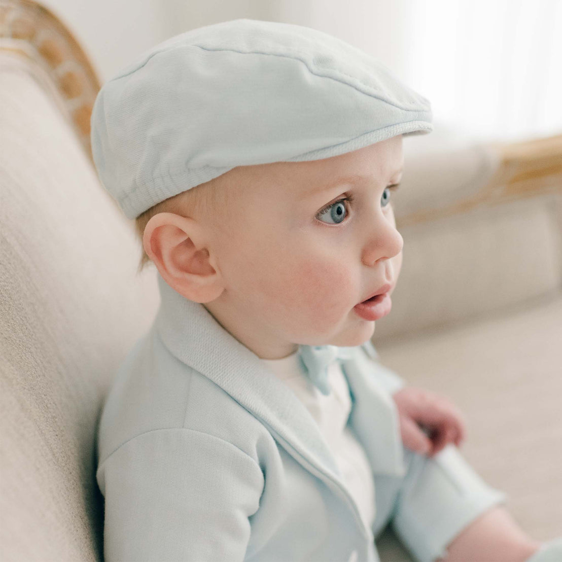 Baby boy in powder blue cotton Milo newsboy cap