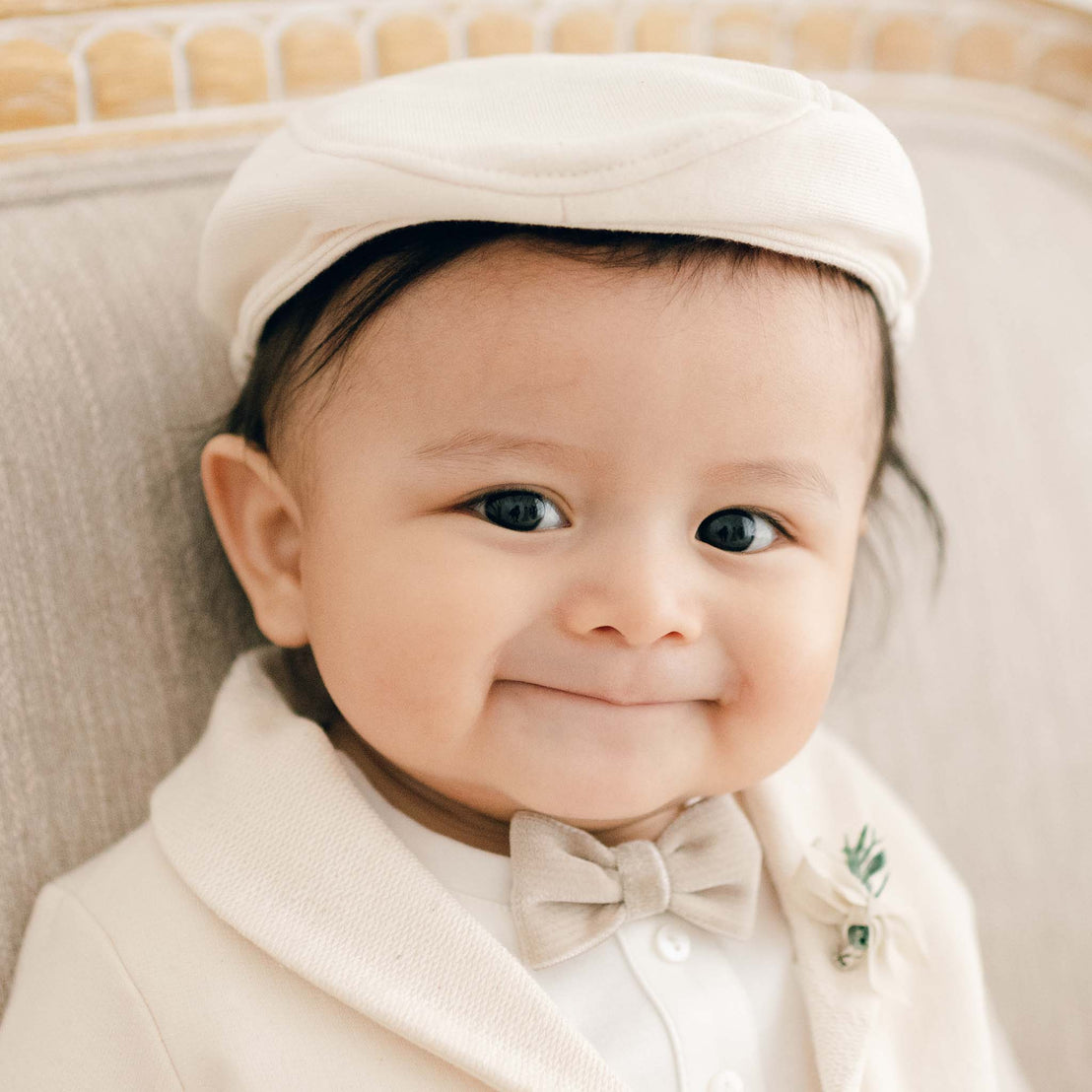 Baby boy in tan cotton newsboy cap
