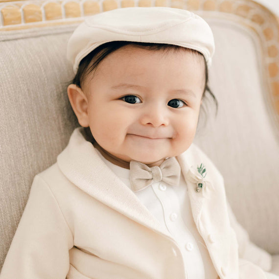 Baby boy in tan cotton newsboy cap