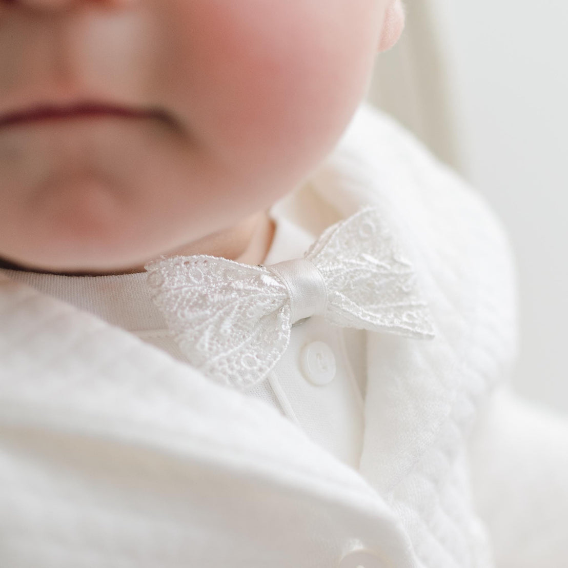 Close-up of a white lace bowtie.