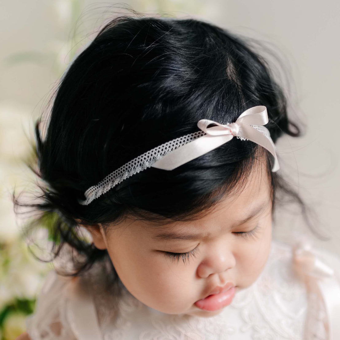 Sophia Silk Ribbon Headband with a soft pink satin bow and delicate lace trim.