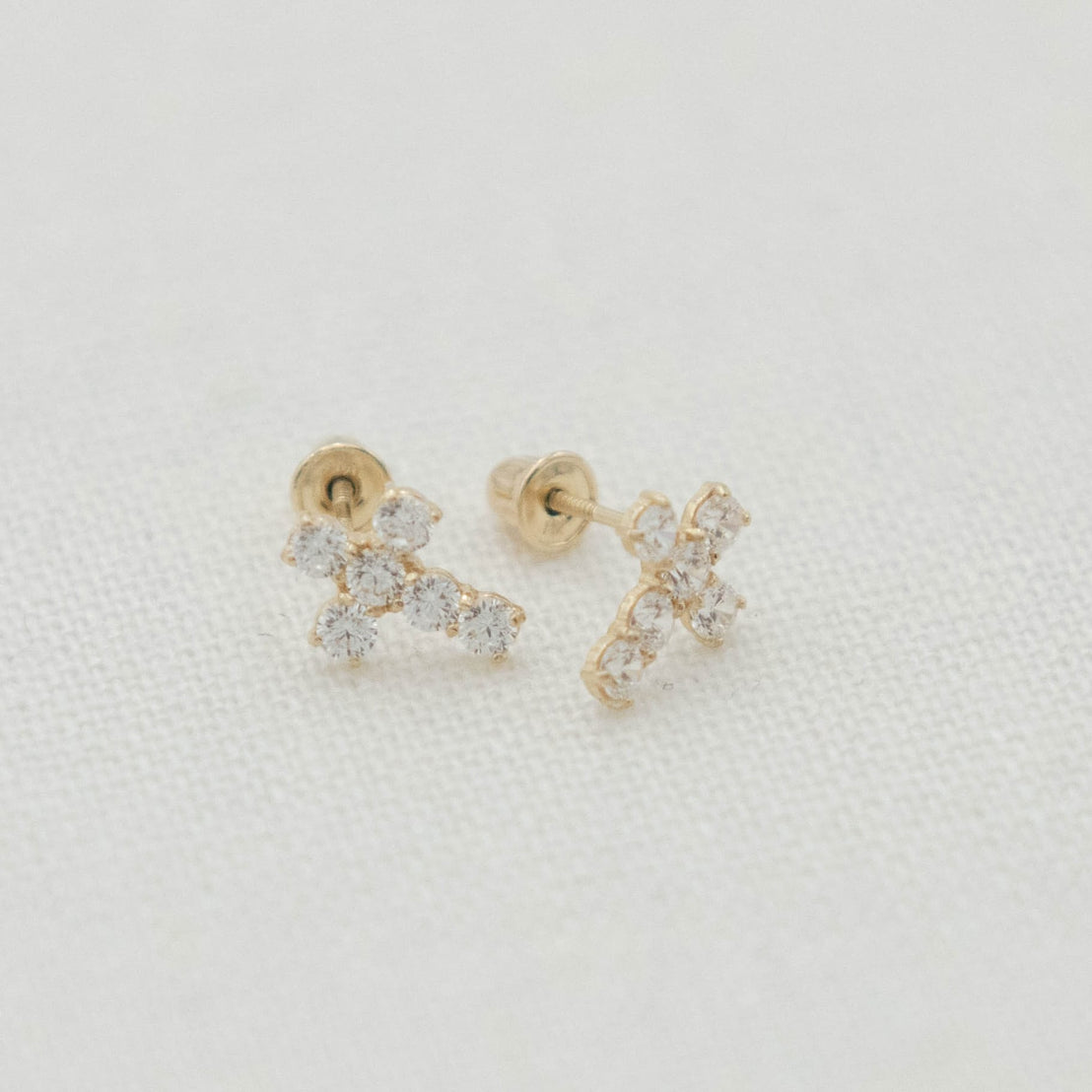 Close-up of the 14k Gold & Stone Cross Earrings with dainty cross charms and soft sparkle detail.