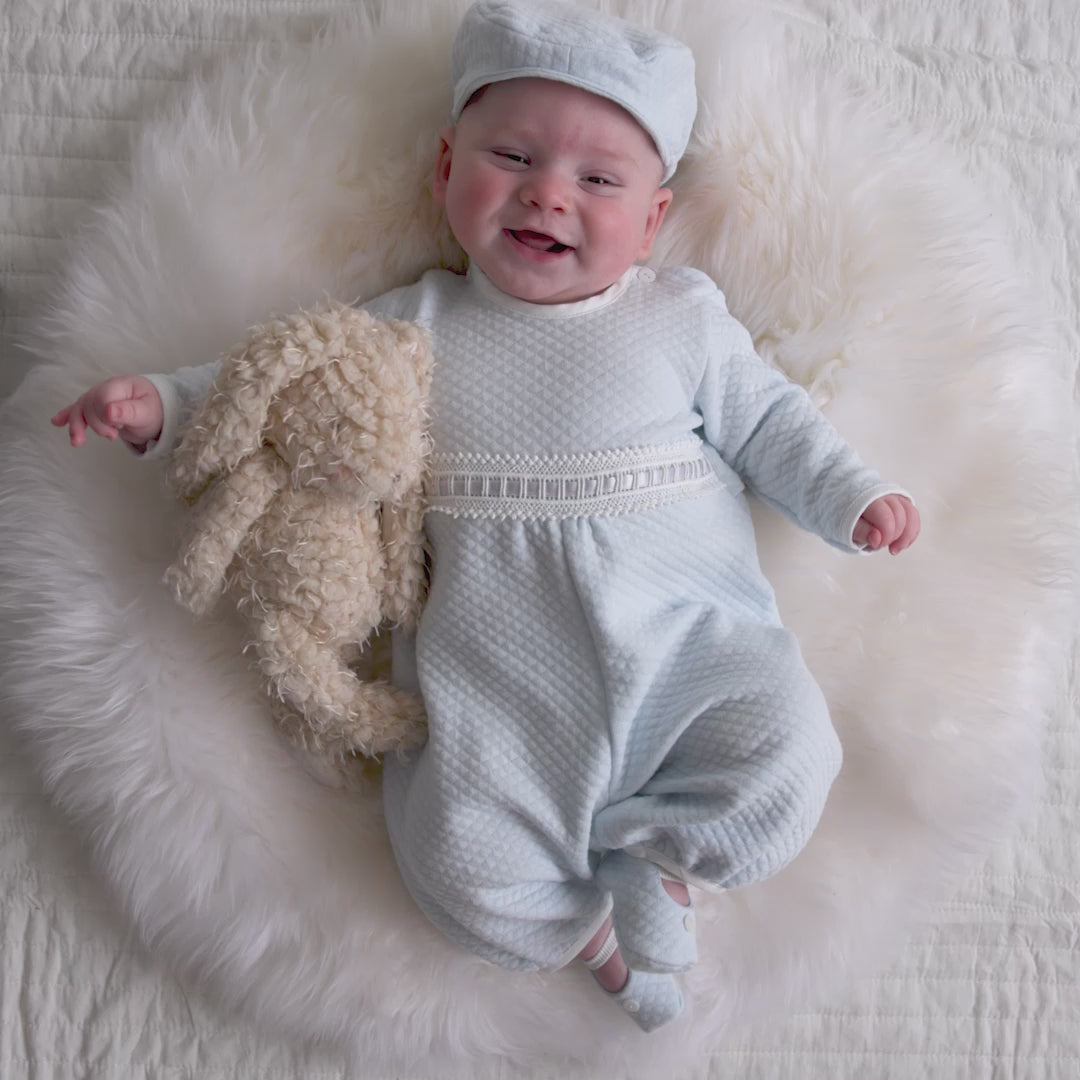 Video of baby boy wearing the Ethan quilted romper - flay lay video