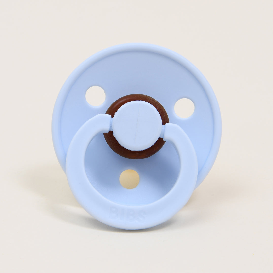 A Bibs Pacifier in Baby Blue, set against a neutral background. The brand "bibs" is visible on the front. 
