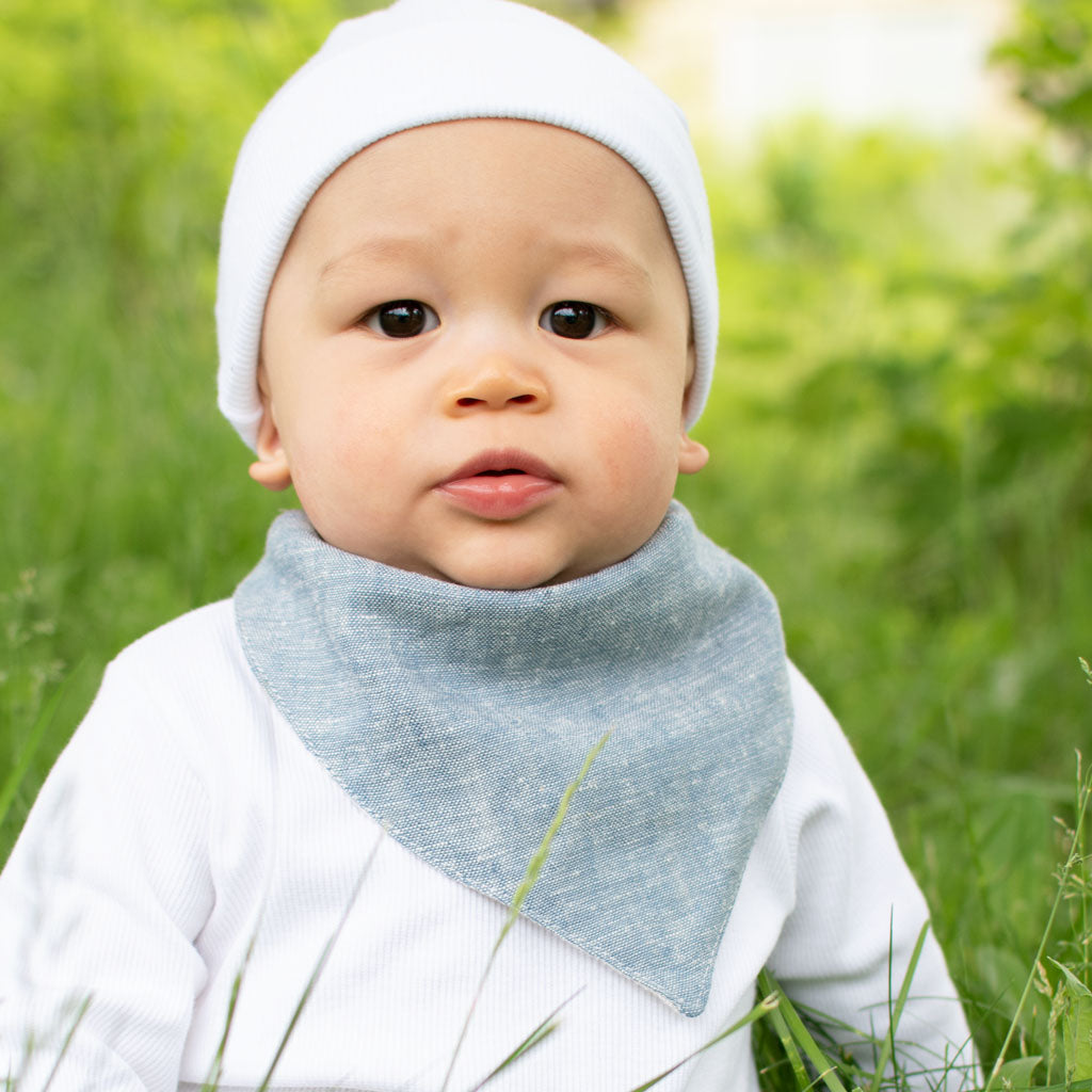 Baby boy wearing the indigo colored Silas Bandana Bib