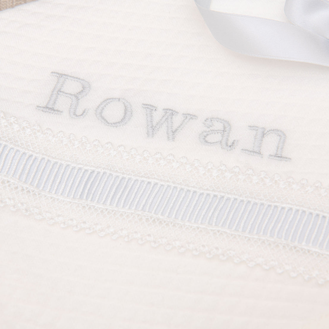 Close up detail of the embroidery on the Rowan personalized baby blanket.