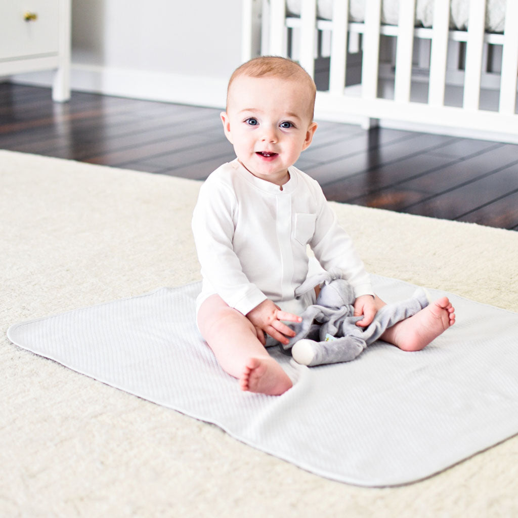 Photo of a baby boy sitting on the Grayson Personalized Blanket.