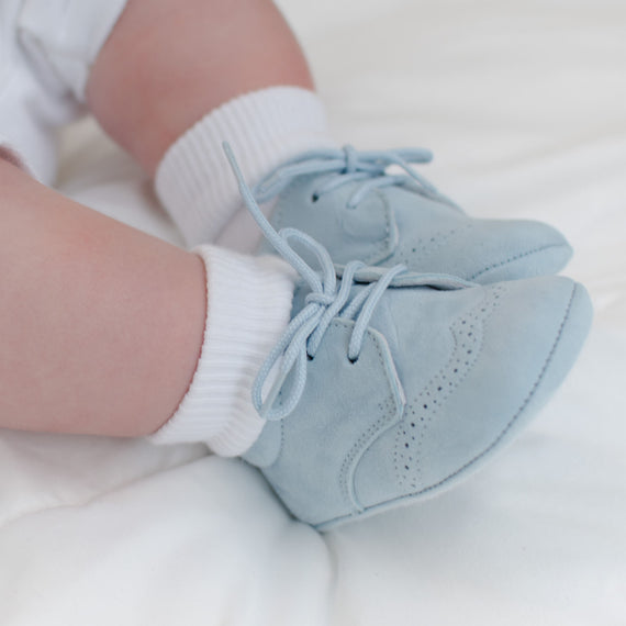 Baby boy wearing the Sky Blue Suede Shoes made from 100% Suede with detailed edging.