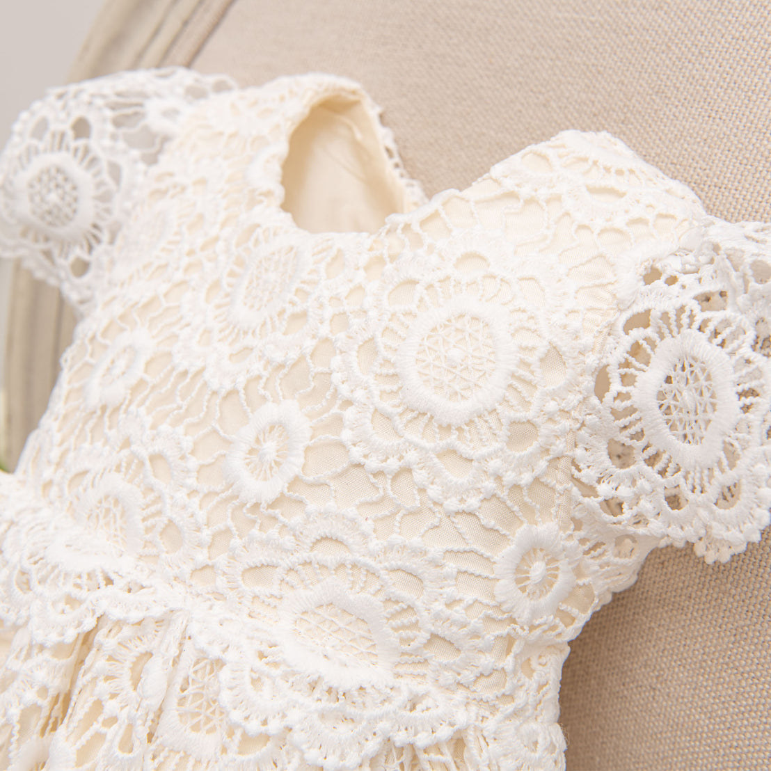 Close up photo of the details on the bodice of the cotton lace baby girl dress.