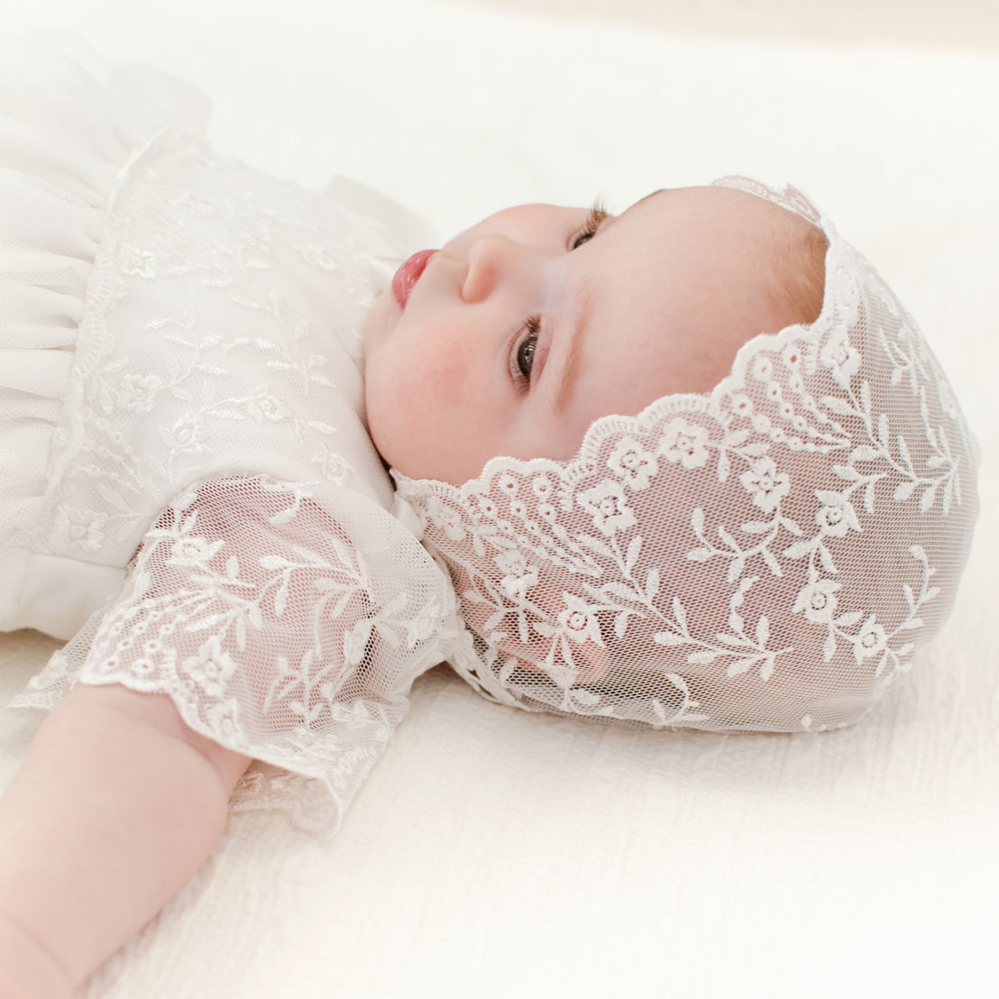 Ella lace bonnet on sleeping baby girl