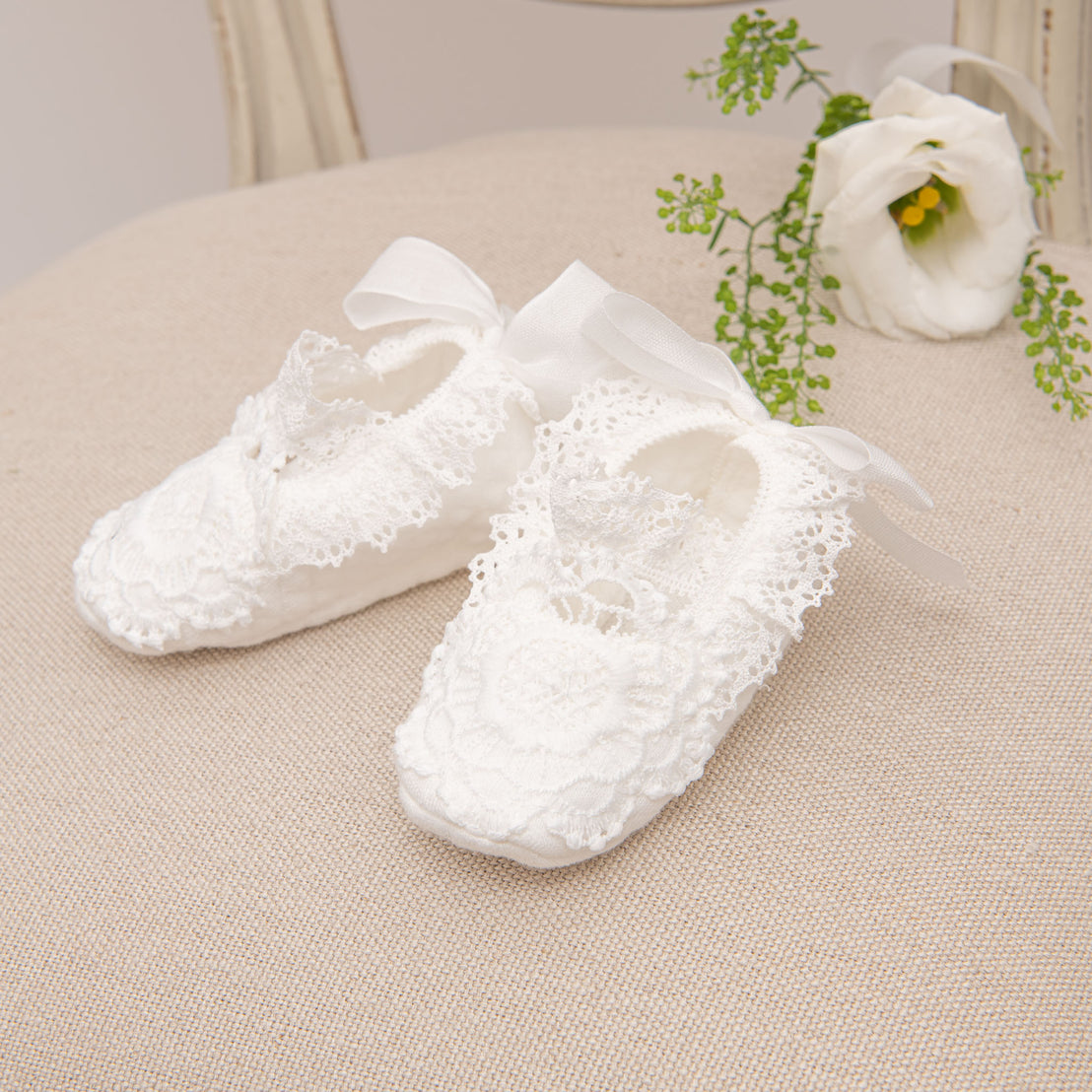 Side profile photo of the Poppy cotton christening booties. 