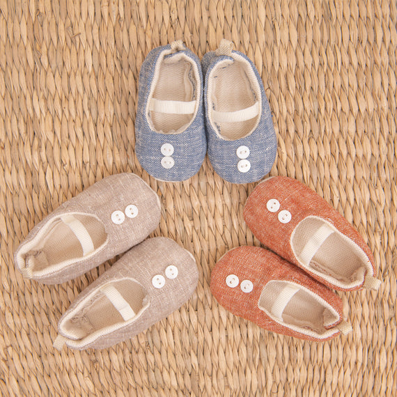 Flat lay photo of all three colors of the Silas Linen Booties, including the colors blue, tan, and red.
